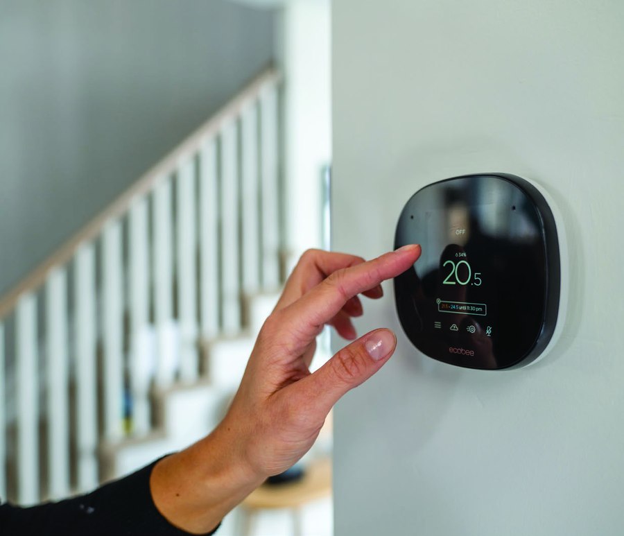 Smart thermostat and stained oak stairs