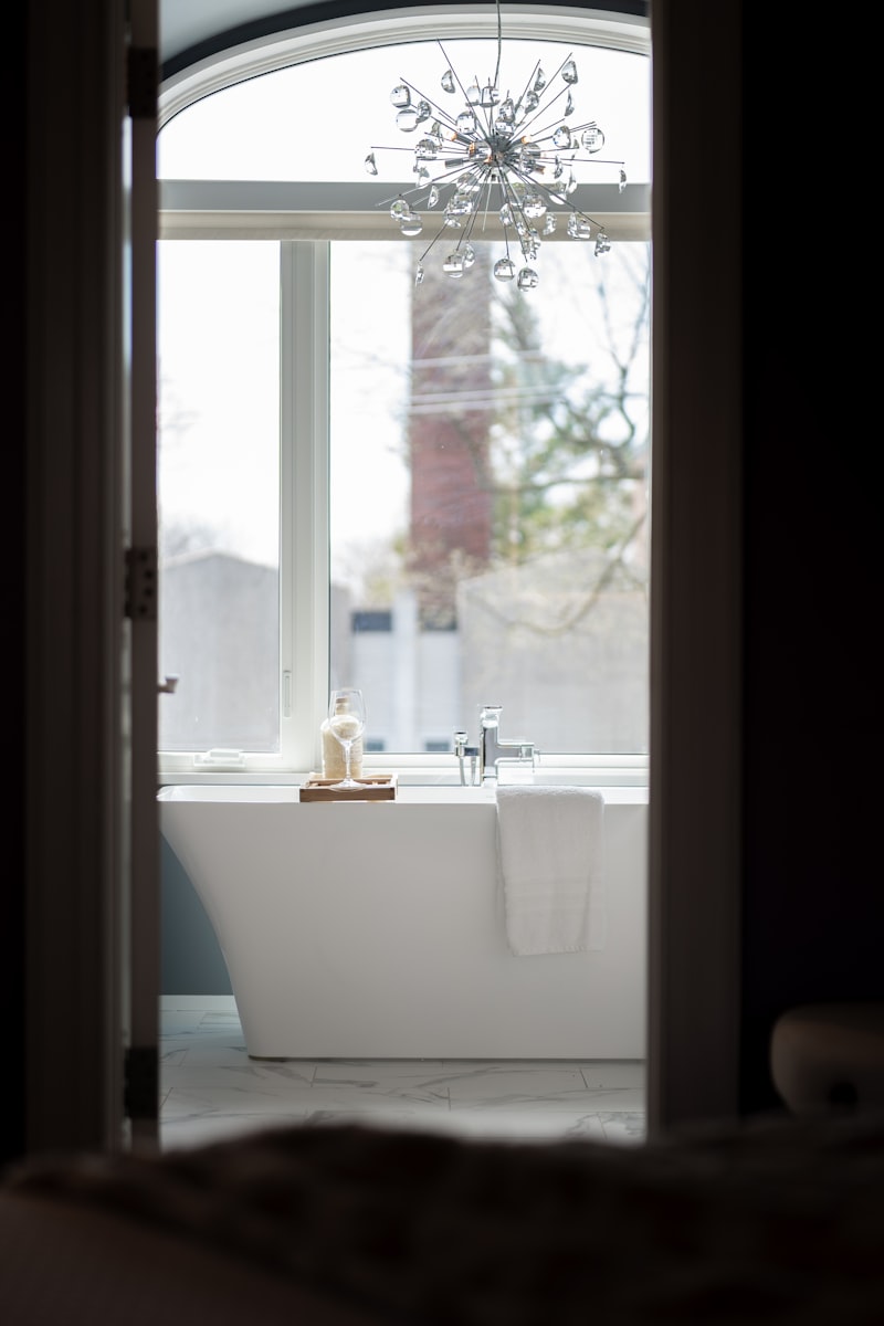 Freestanding Soaking Tub Installation Under an Arched Window