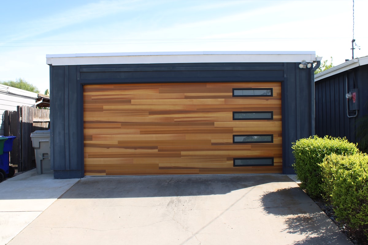Modern Wood-Look Garage Door with a Column of Glass Window Inserts